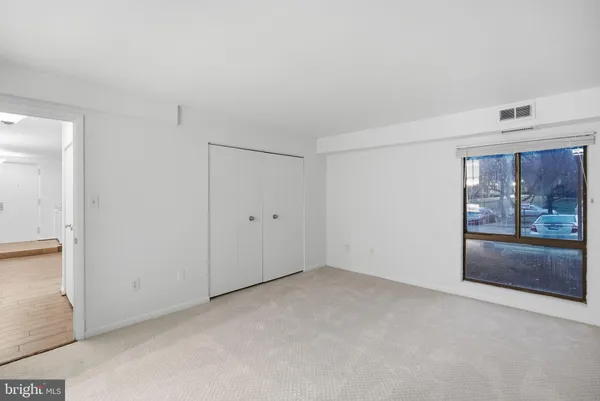 a bedroom with a bed and chandelier