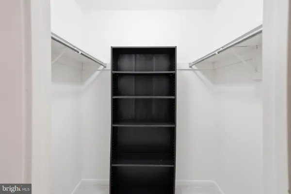a bathroom with a granite countertop sink toilet and mirror