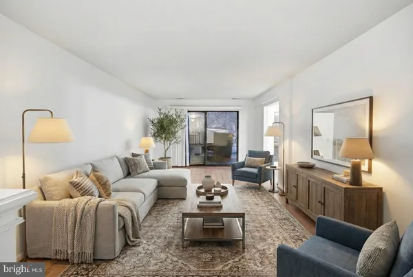 a living room with furniture and wooden floor