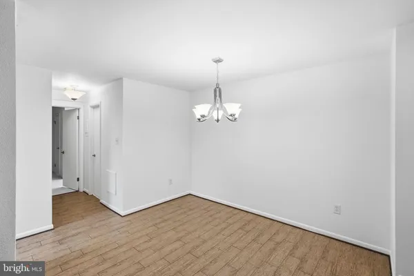 a view of a room with wooden floor and chandelier