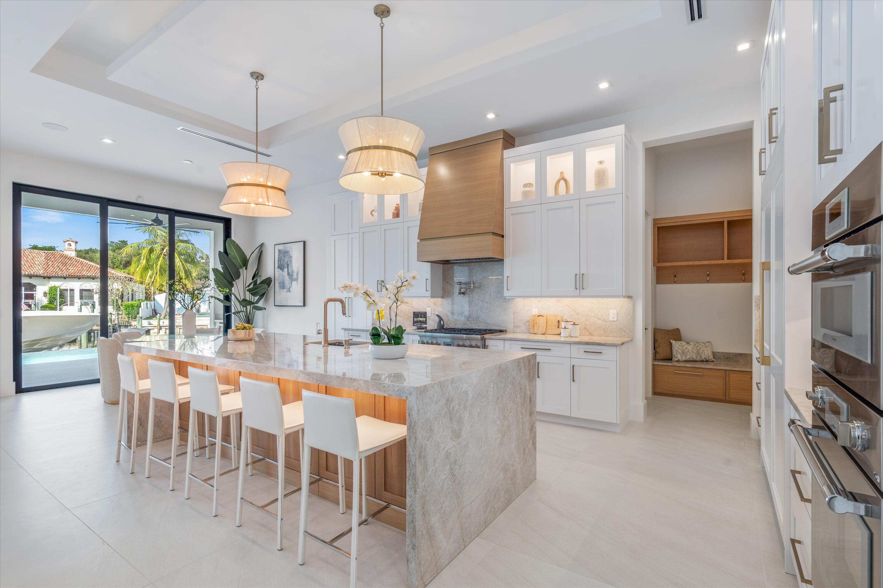 11331 Avery Road Palm Beach Gardens, FL 33410 - Photo 11 of 110 a large kitchen with a table and chairs