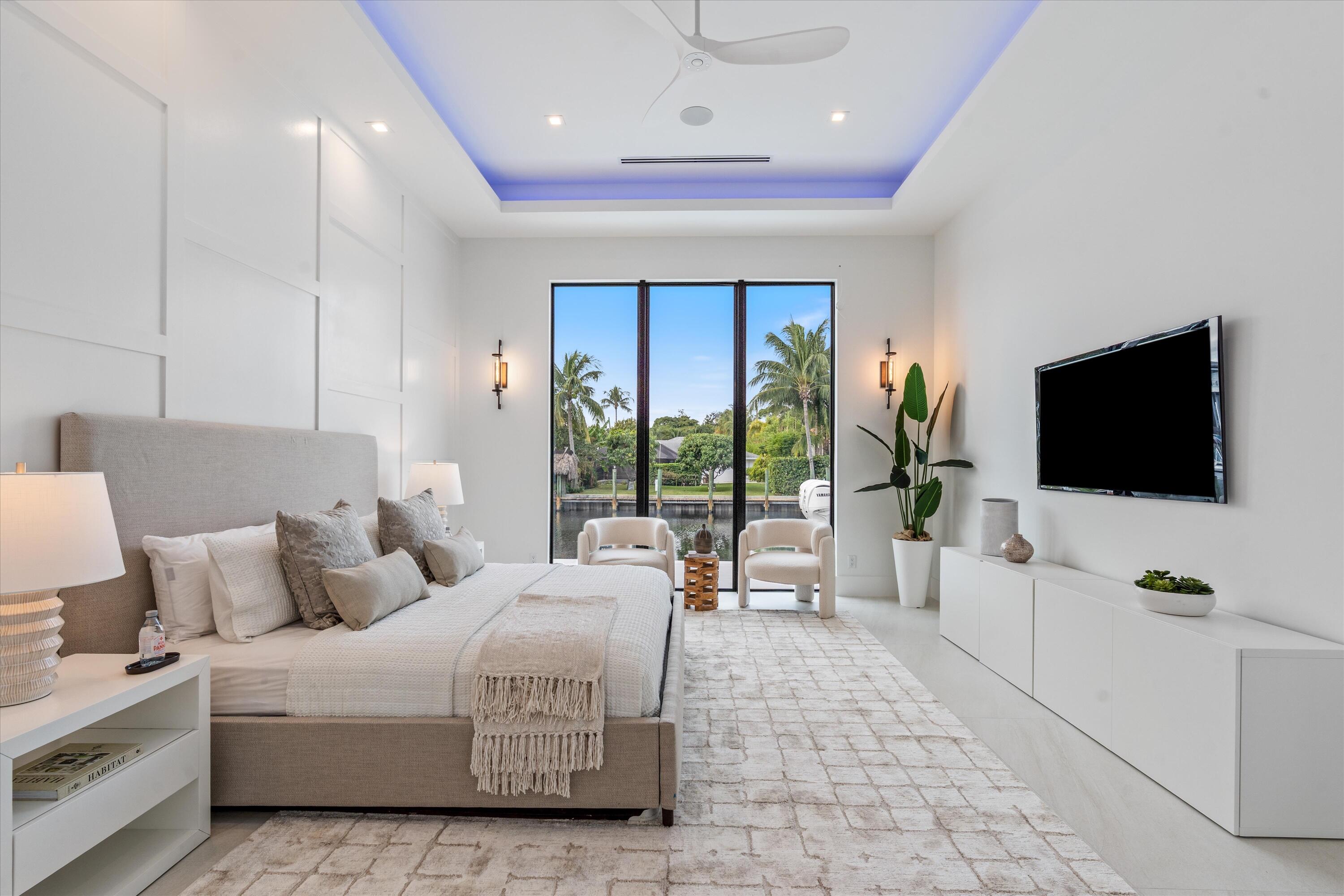 11331 Avery Road Palm Beach Gardens, FL 33410 - Photo 16 of 110 a spacious bedroom with a large bed and a flat screen tv