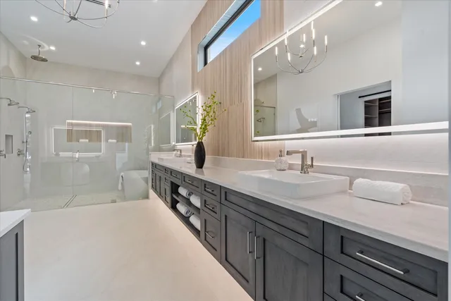 a bathroom with a granite countertop sink and a bathtub