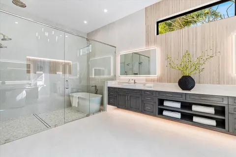 a bathroom with double vanity sink and a mirror