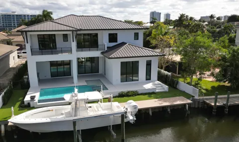 a aerial view of a house with swimming pool table and chairs