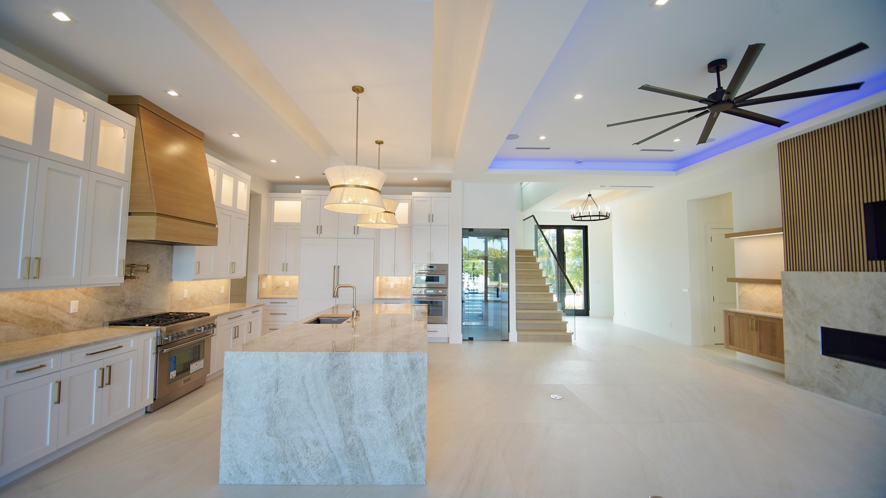 11331 Avery Road Palm Beach Gardens, FL 33410 - Photo 22 of 110 a open kitchen with stainless steel appliances kitchen island granite countertop a sink and a stove