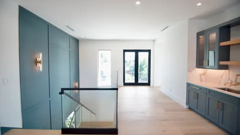 a very nice looking room with a large window and chandelier