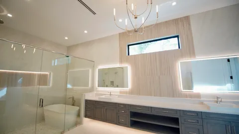 a spacious bathroom with a granite countertop sink a mirror and a window