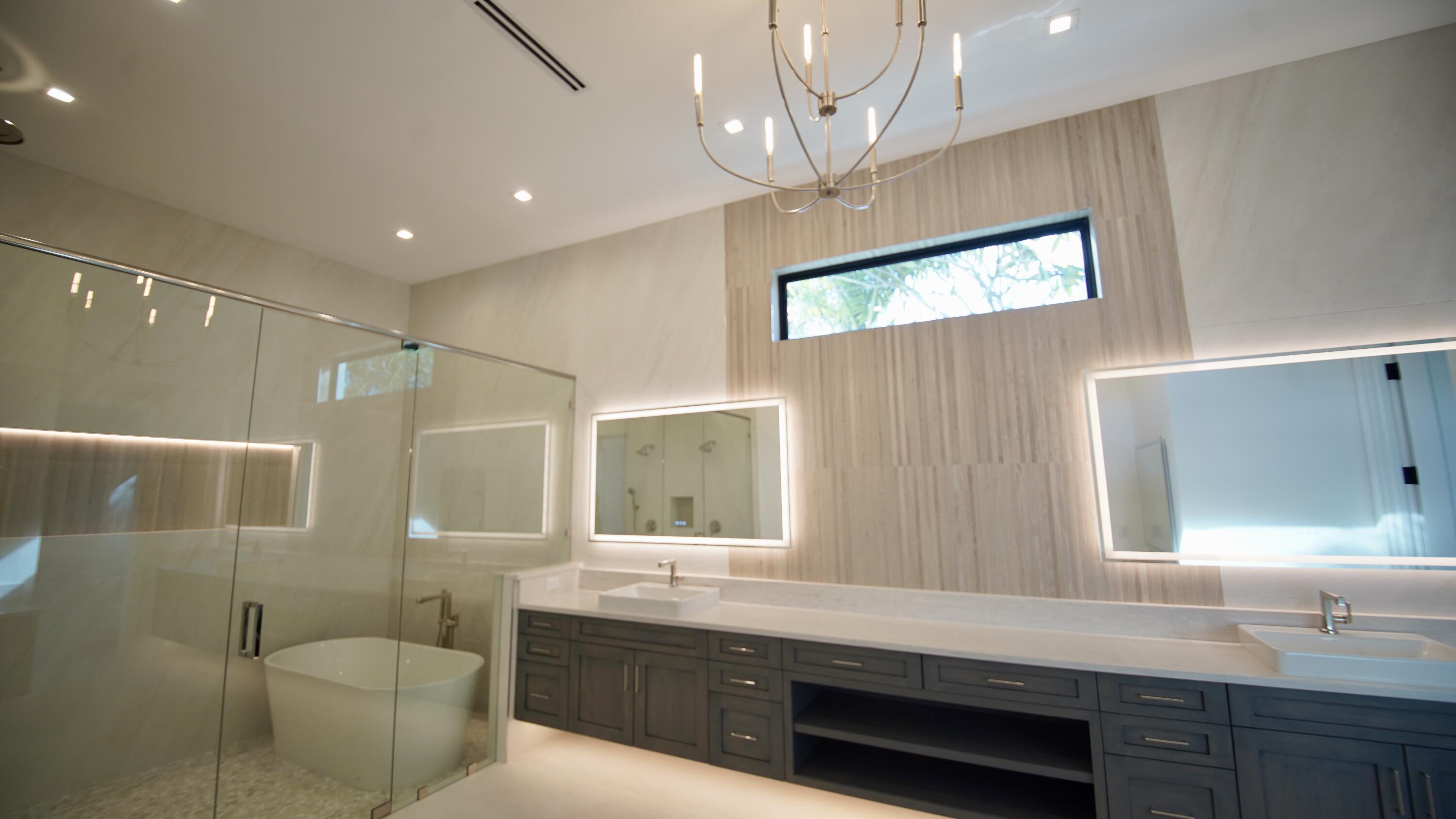 11331 Avery Road Palm Beach Gardens, FL 33410 - Photo 37 of 110 a bathroom with double vanity sink and a mirror