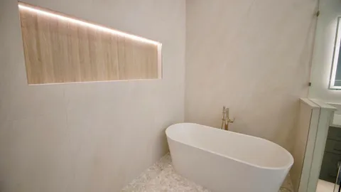 a bathroom with a granite countertop sink and a bathtub