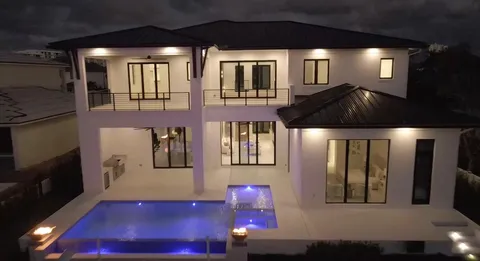a living room with furniture a chandelier and large window