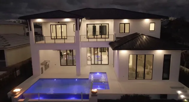 a living room with furniture a chandelier and large window