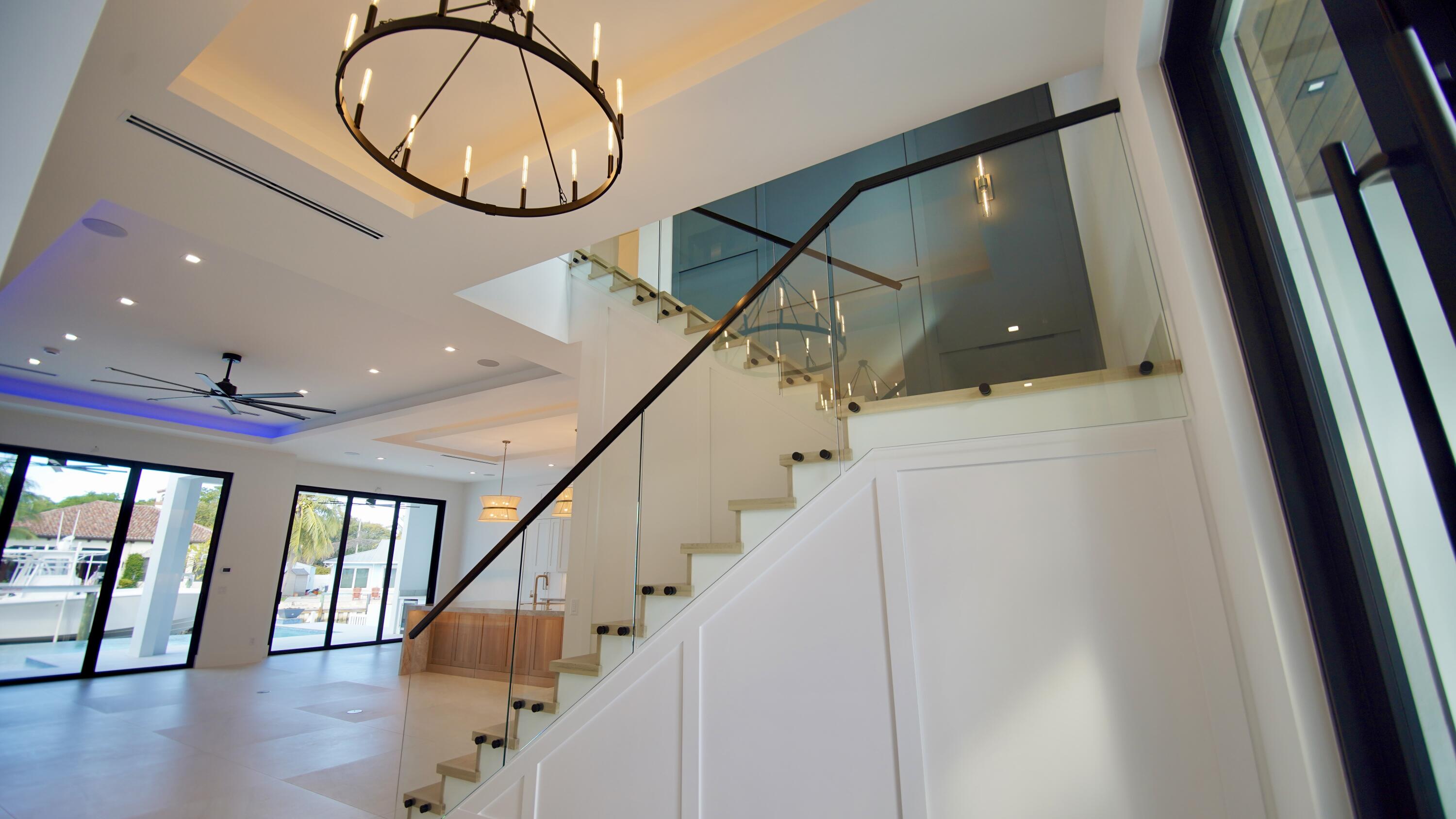 11331 Avery Road Palm Beach Gardens, FL 33410 - Photo 51 of 110 a view of staircase with railing and a chandelier