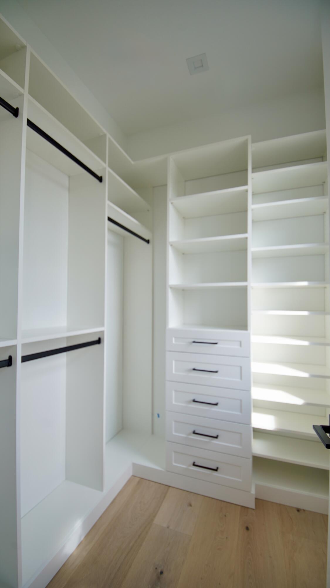 11331 Avery Road Palm Beach Gardens, FL 33410 - Photo 85 of 110 a view of walk in closet with empty racks