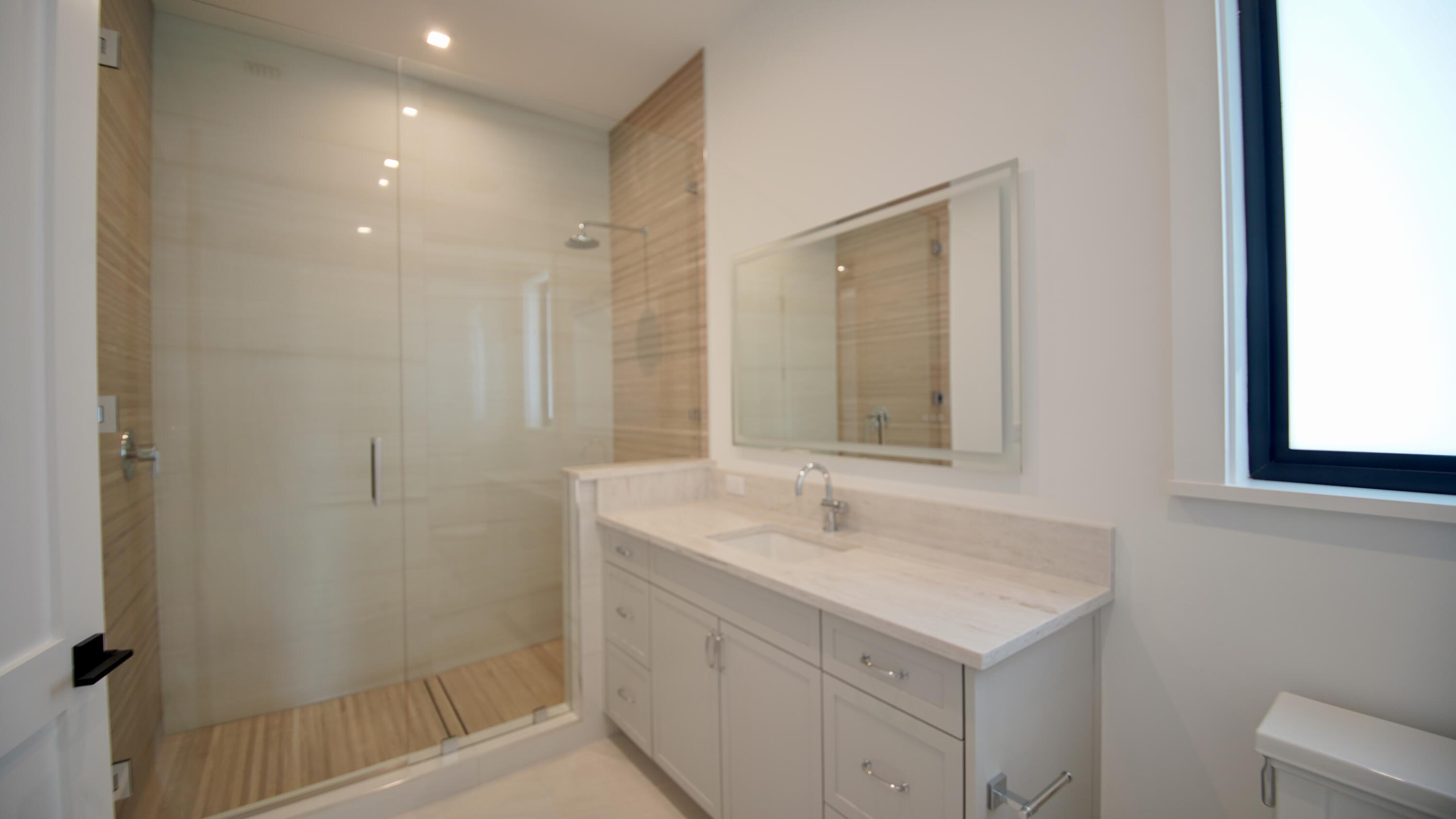 11331 Avery Road Palm Beach Gardens, FL 33410 - Photo 86 of 110 a bathroom with a sink and a mirror