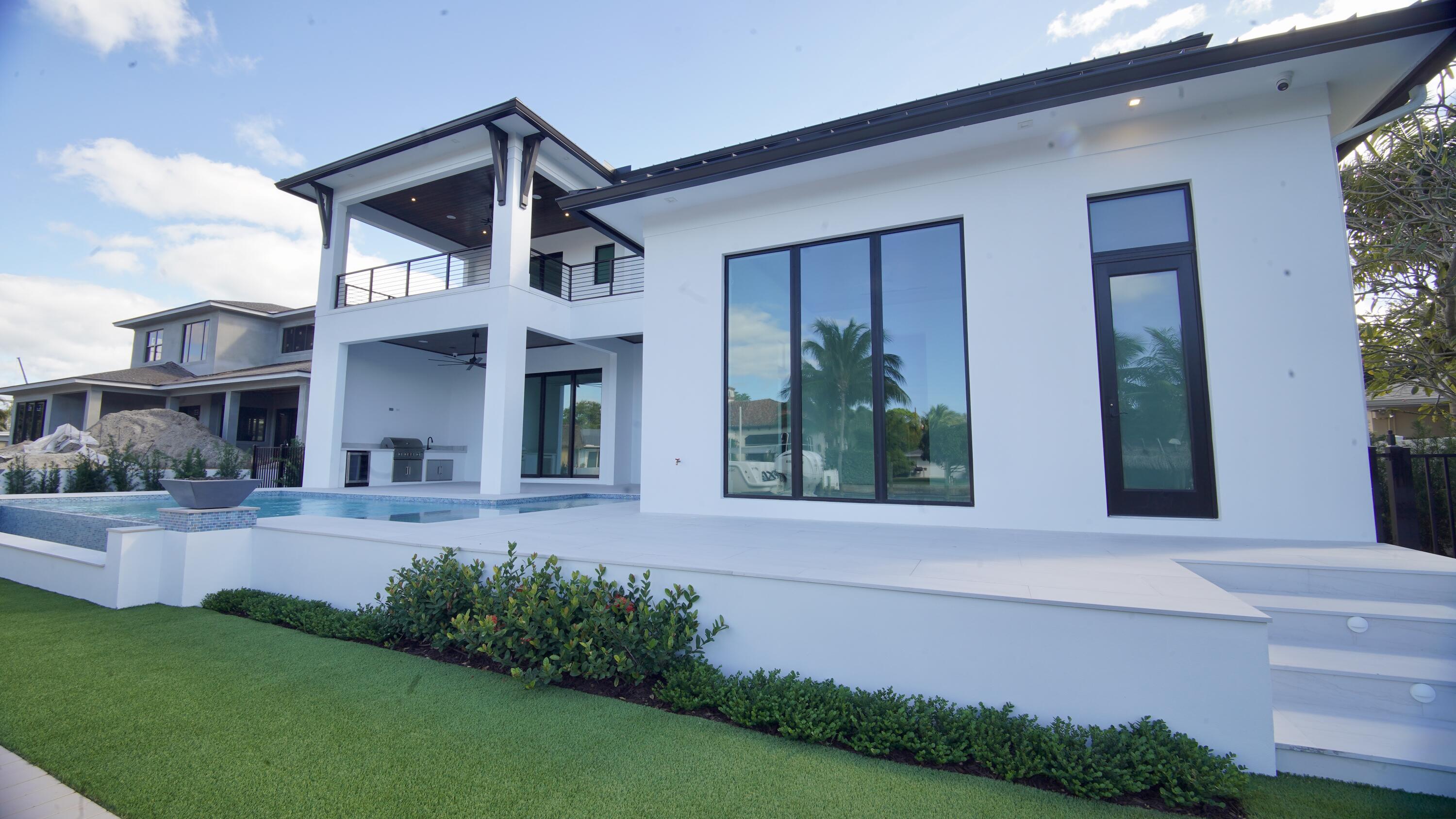 11331 Avery Road Palm Beach Gardens, FL 33410 - Photo 89 of 110 a front view of a house with garden