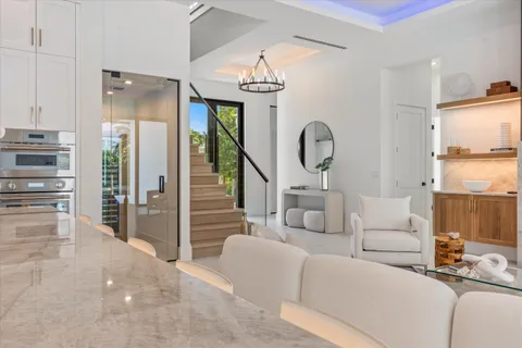 a view of a balcony with chairs and wooden floor