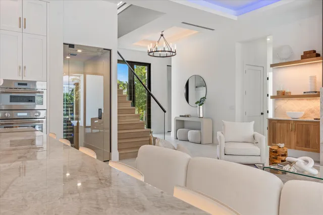 a view of a balcony with chairs and wooden floor