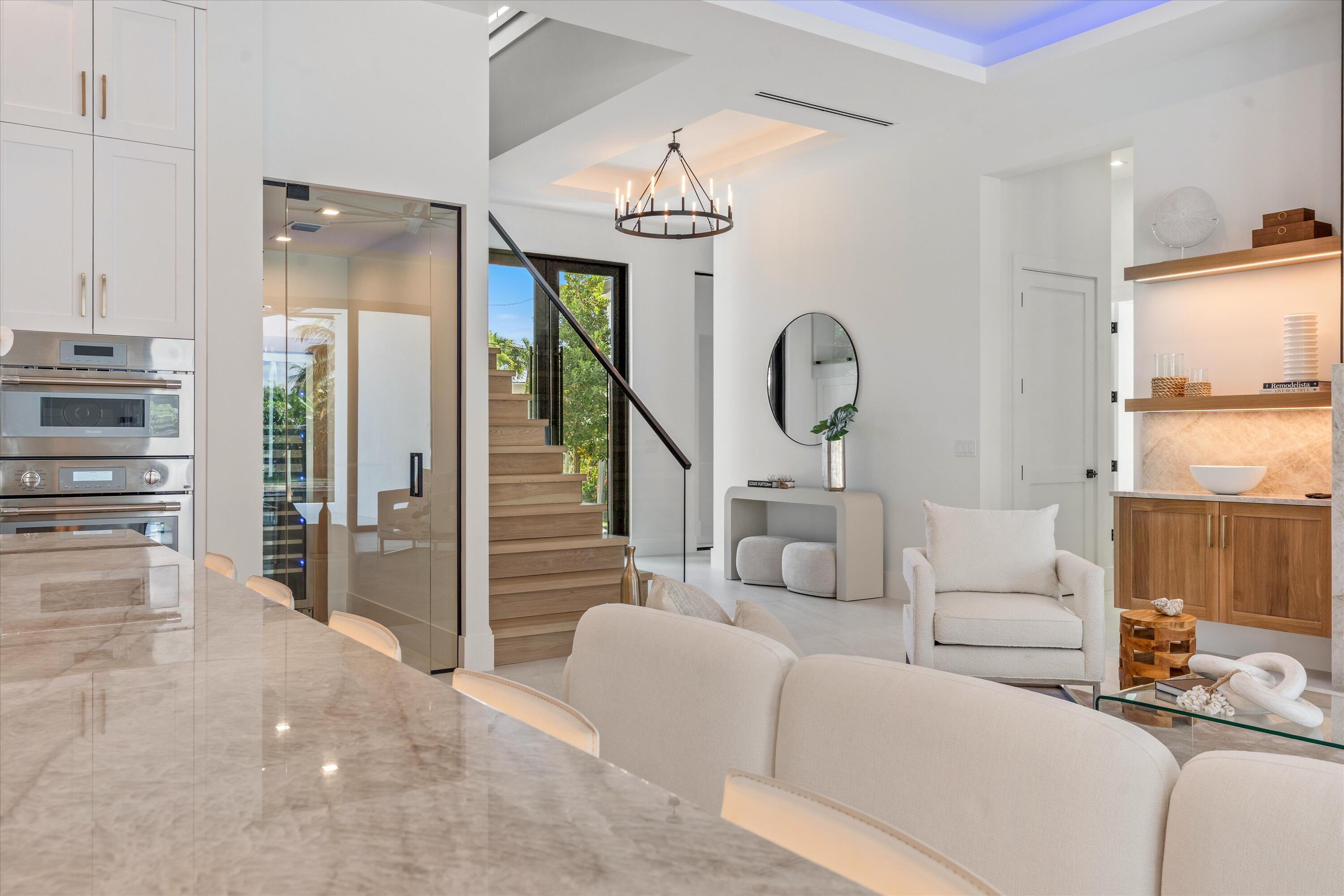 11331 Avery Road Palm Beach Gardens, FL 33410 - Photo 10 of 110 a living room with furniture a chandelier and large window