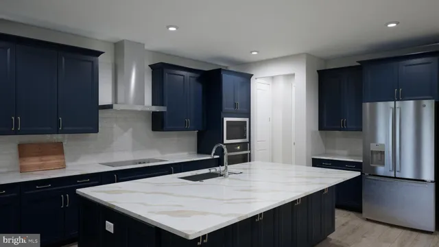 a kitchen with a sink a refrigerator and cabinets