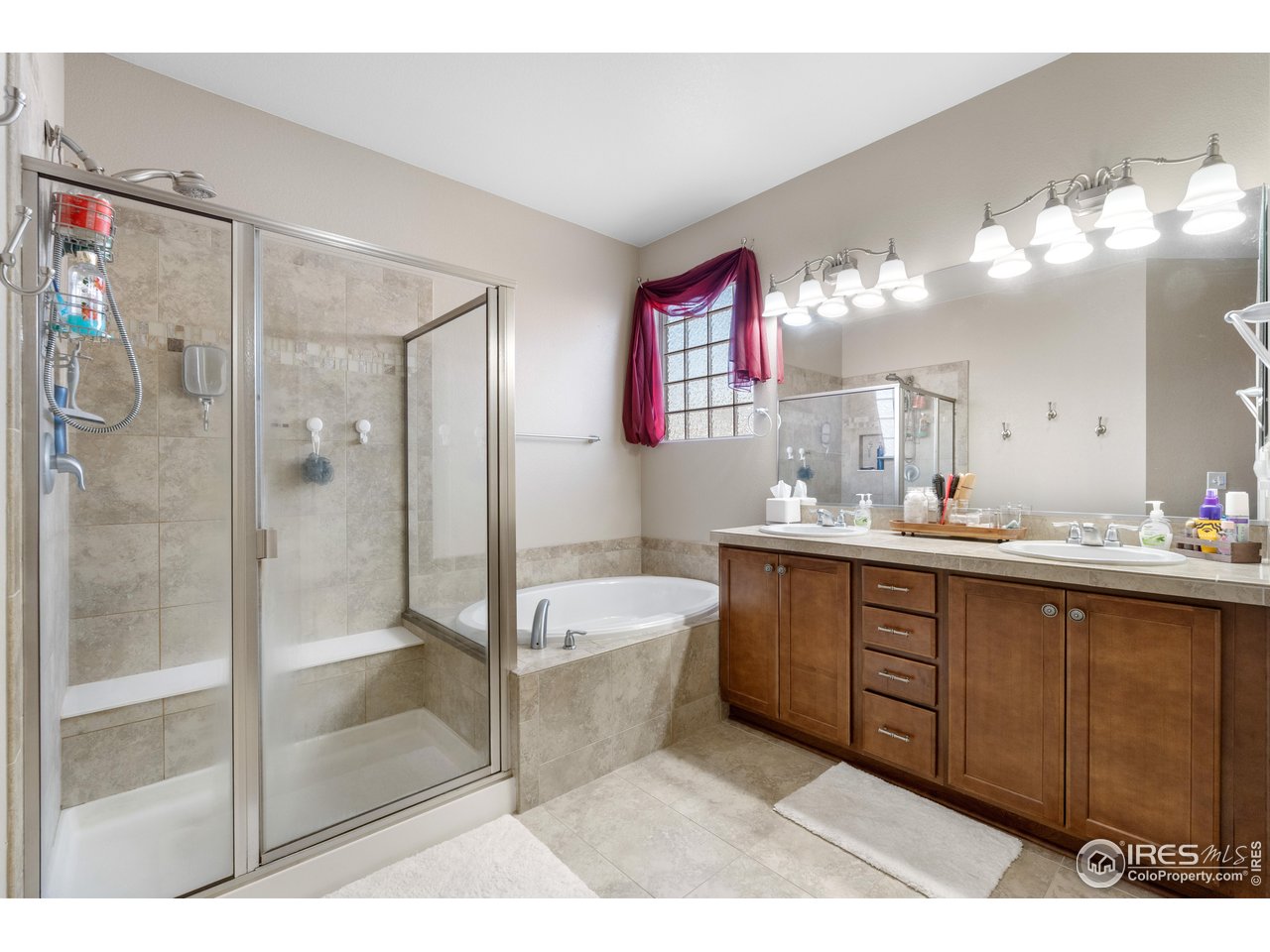 5865 Quarry Street Timnath, CO 80547 - Photo 16 of 47 a spacious bathroom with a bathtub shower sink mirror and toilet