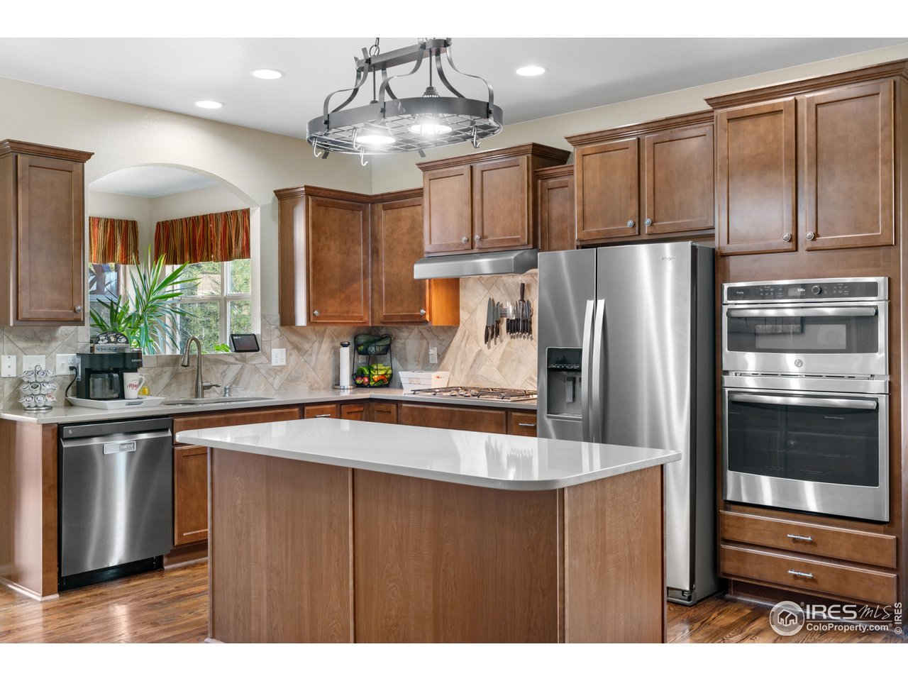 5865 Quarry Street Timnath, CO 80547 - Photo 2 of 47 a kitchen with stainless steel appliances granite countertop a refrigerator and a sink