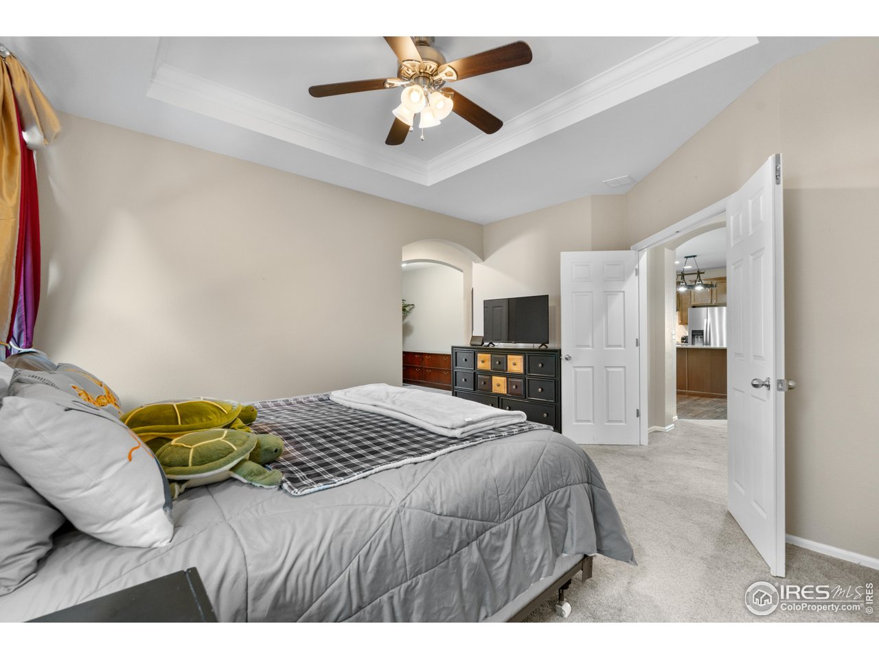 5865 Quarry Street Timnath, CO 80547 - Photo 22 of 47 a bedroom with a bed and a chandelier