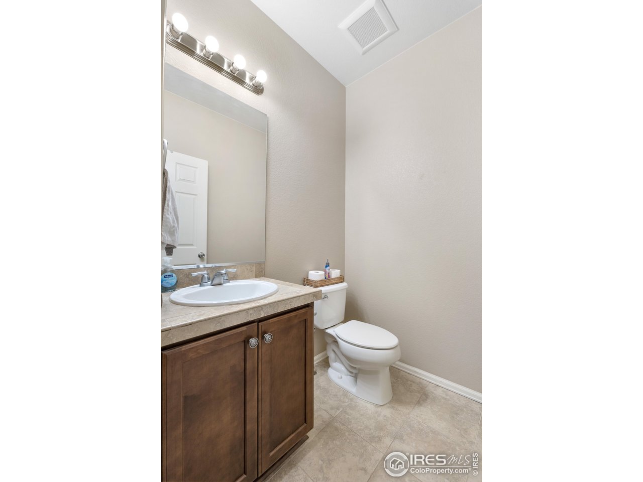 5865 Quarry Street Timnath, CO 80547 - Photo 23 of 47 a bathroom with a toilet sink and mirror