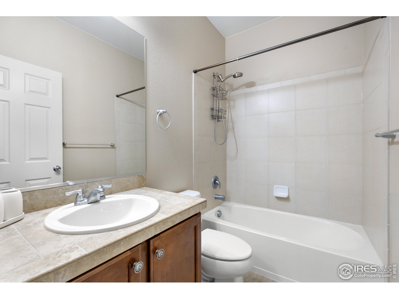 5865 Quarry Street Timnath, CO 80547 - Photo 26 of 47 a bathroom with a sink double vanity granite tub shower and a mirror