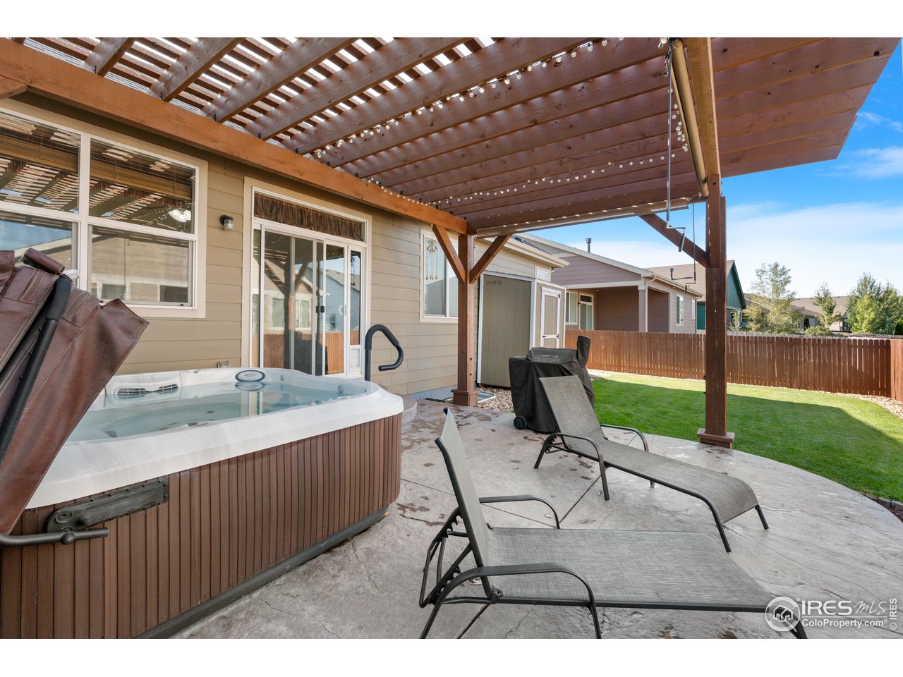 5865 Quarry Street Timnath, CO 80547 - Photo 32 of 47 a view of a patio with table and chairs with wooden floor and fence