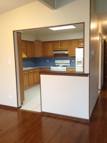 10909 Rutherford Avenue Worth, IL 60482 - Photo 4 of 9 a kitchen with wooden floor