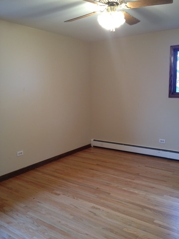 10909 Rutherford Avenue Worth, IL 60482 - Photo 8 of 9 a view of an empty room and wooden floor