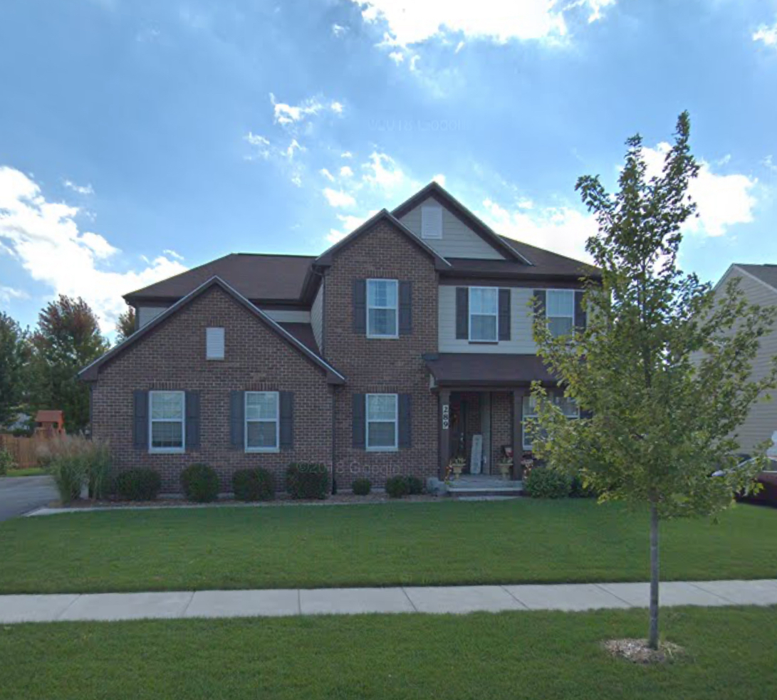 a front view of a house with a garden