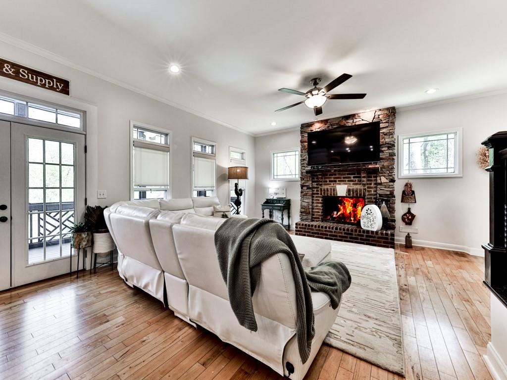 1141 Addington Lane Waleska, GA 30183 - Photo 19 of 105 a living room with furniture a fireplace and a flat screen tv