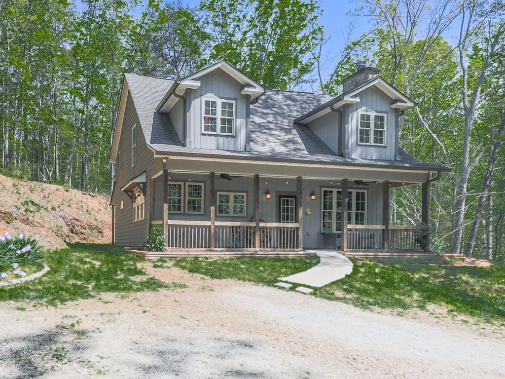 1141 Addington Lane Waleska, GA 30183 - Photo 2 of 105 a front view of a house with a garden and trees
