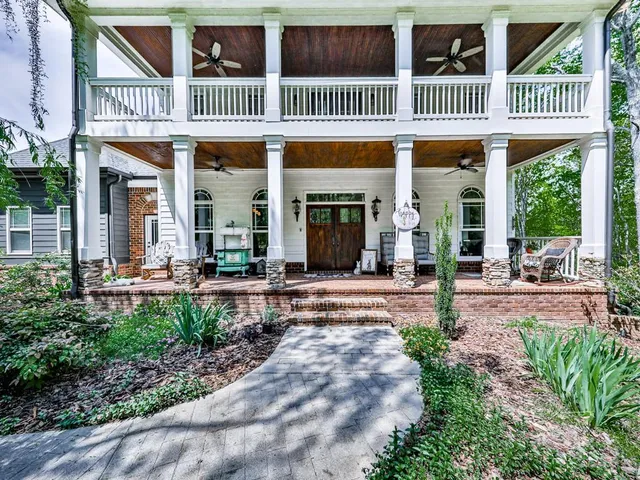a bedroom with a bed and lamp on desk