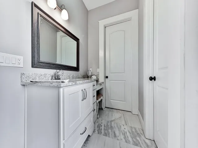 a view of a wooden house with a yard and large trees