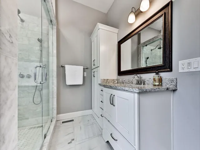 an aerial view of a house with garden space and street view