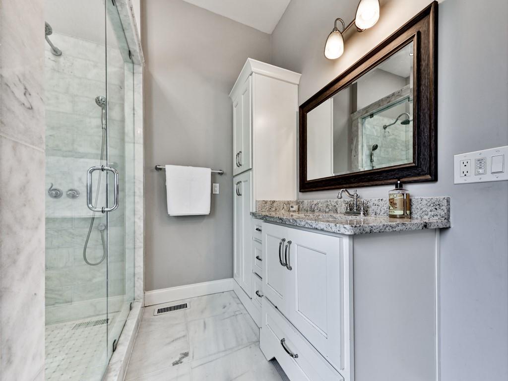 1141 Addington Lane Waleska, GA 30183 - Photo 34 of 105 a bathroom with a granite countertop sink mirror and a shower