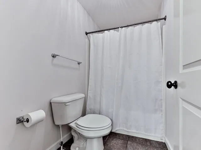 a bedroom with a bed and a ceiling fan