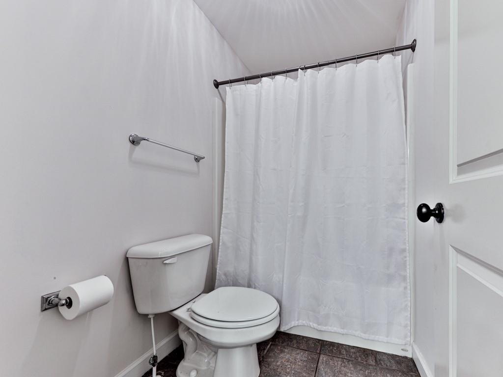 1141 Addington Lane Waleska, GA 30183 - Photo 40 of 105 a bathroom with a toilet and a shower curtain