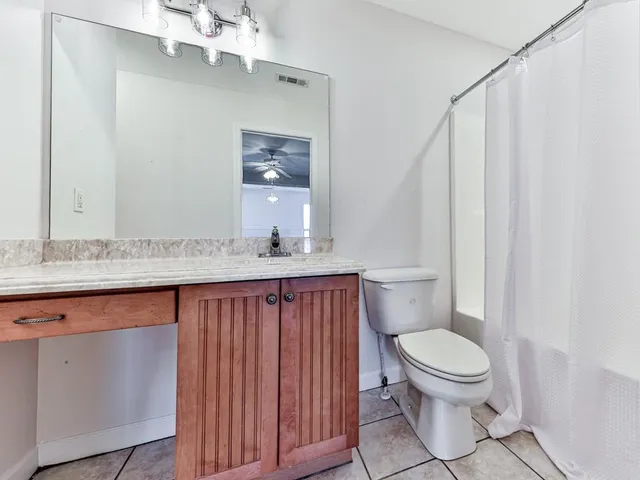 a view of a dirt road with trees in the background