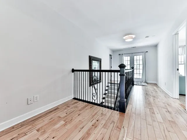 an aerial view of a house with a yard and trees all around