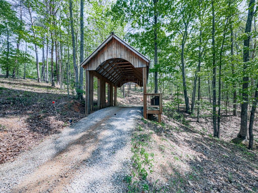1141 Addington Lane Waleska, GA 30183 - Photo 73 of 105 a view of a wooden house with a yard and large trees