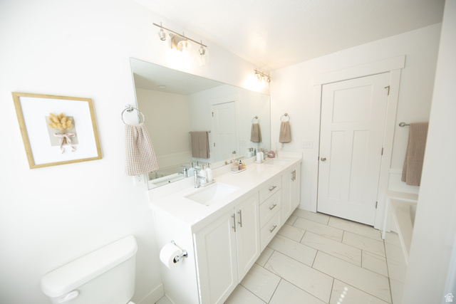 1404 East Rustic Wood Court Sandy, UT 84092 - Photo 18 of 33 Double vanity with undermount sinks, white cabinetry, and a spacious countertop