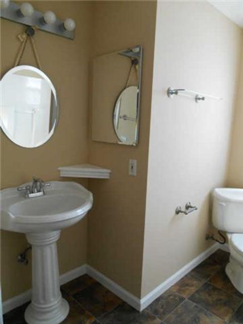 3101 Curd Road Mount Juliet, TN 37122 - Photo 11 of 14 a bathroom with a toilet a sink and mirror