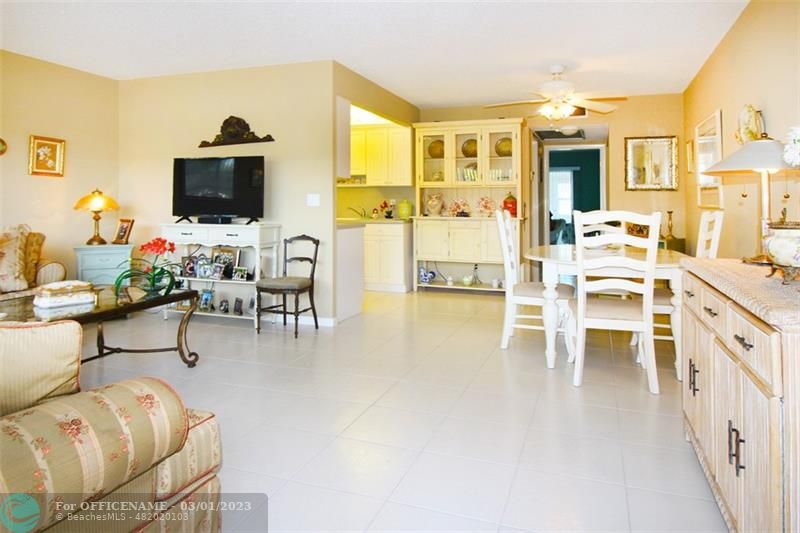 1055 Cambridge C, Unit 1055 Deerfield Beach, FL 33442 - Photo 1 of 52 a living room with furniture a flat screen tv and a dining table