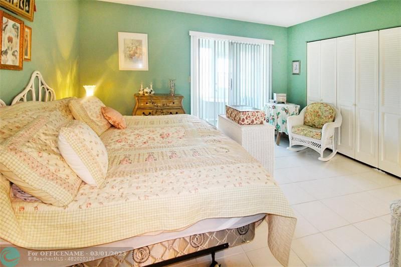 1055 Cambridge C, Unit 1055 Deerfield Beach, FL 33442 - Photo 15 of 52 a bedroom with a bed and wooden floor