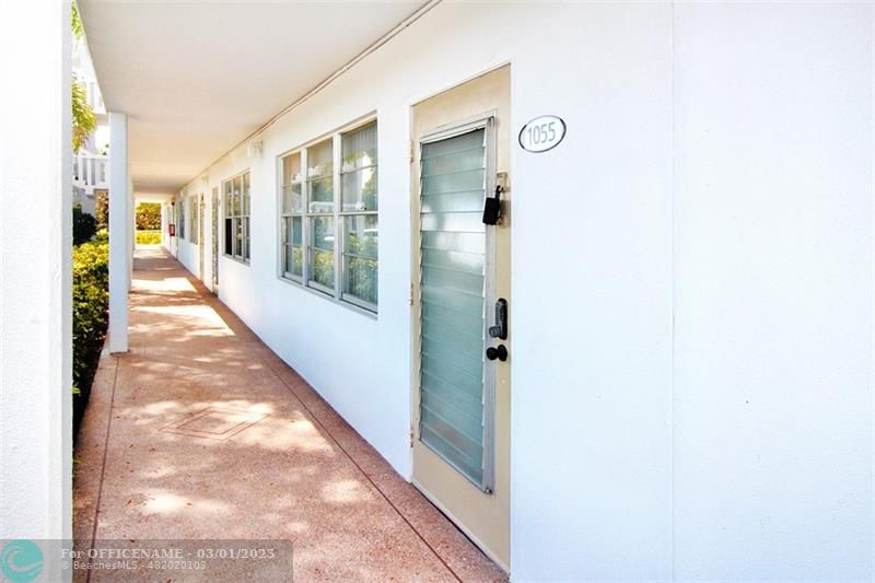 1055 Cambridge C, Unit 1055 Deerfield Beach, FL 33442 - Photo 23 of 52 a view of a hallway with windows