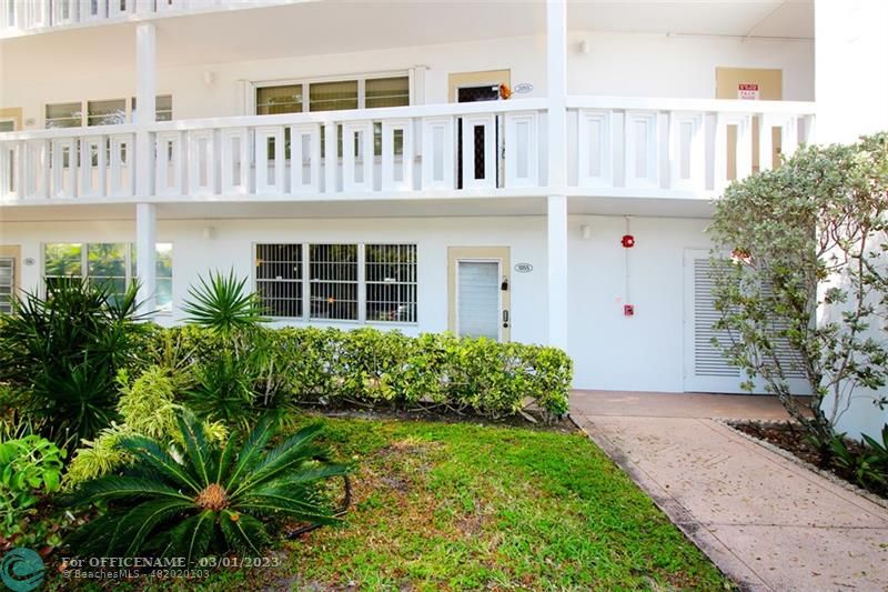 1055 Cambridge C, Unit 1055 Deerfield Beach, FL 33442 - Photo 24 of 52 a front view of a house with garden